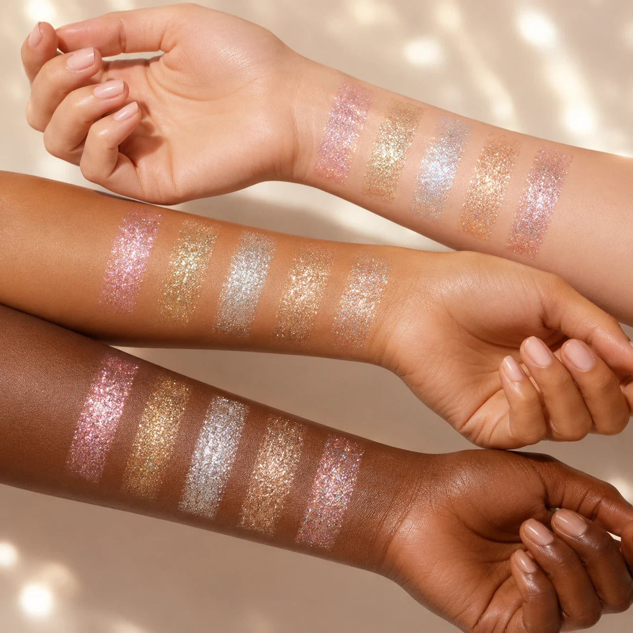 Five signature shimmer pigment swatches on three skin tones